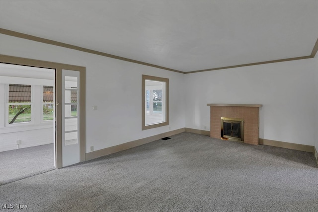 unfurnished living room featuring carpet, a fireplace, and a wealth of natural light