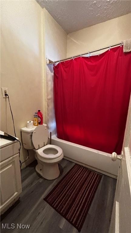1227 E 113th St, Cleveland, OH 44108 - bathroom with shower / bathtub combination with curtain, toilet, vanity, a textured ceiling, and wood finished floors