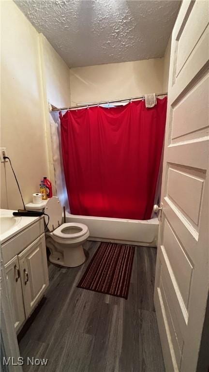 1227 E 113th St, Cleveland, OH 44108 - bathroom with a textured ceiling, toilet, wood finished floors, vanity, and shower / tub combo with curtain