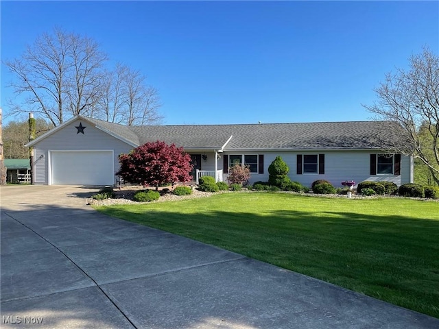 ranch-style house featuring an attached garage, concrete driveway, and a front yard