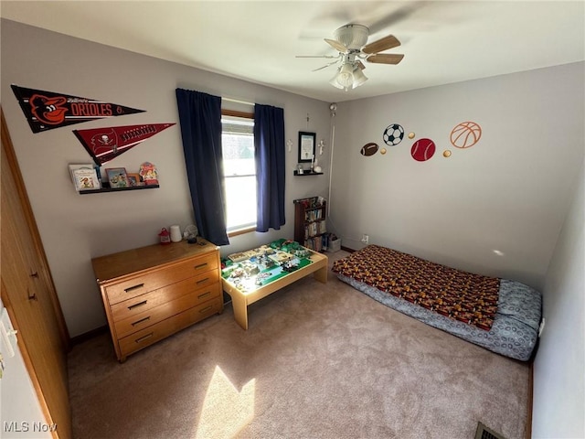 bedroom with ceiling fan, visible vents, and light colored carpet