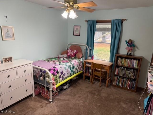 bedroom featuring dark colored carpet and a ceiling fan