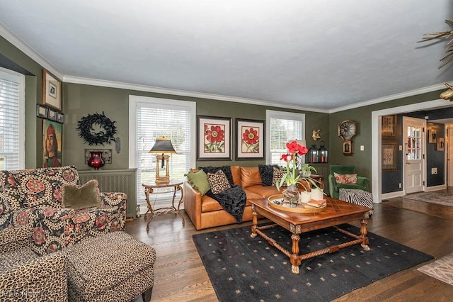 living area with ornamental molding, baseboards, and wood finished floors