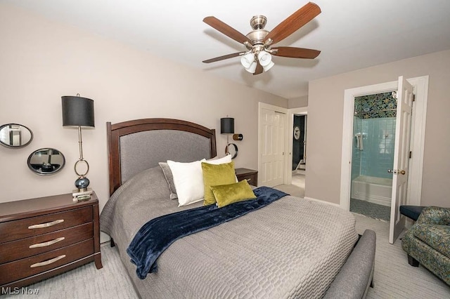 bedroom with connected bathroom and a ceiling fan