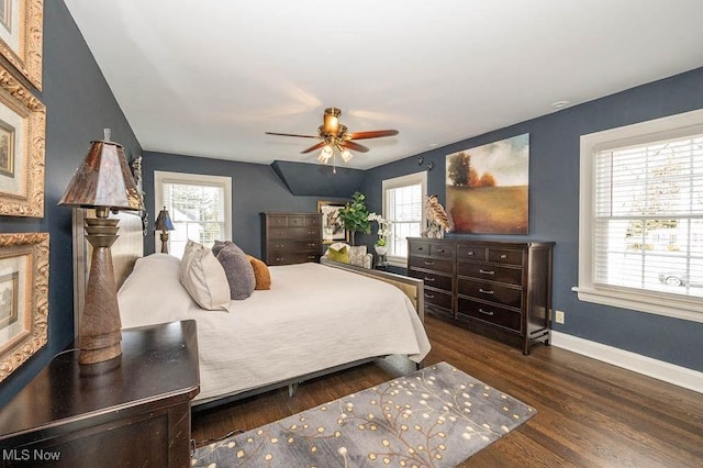 bedroom with ceiling fan, baseboards, and dark wood-style flooring