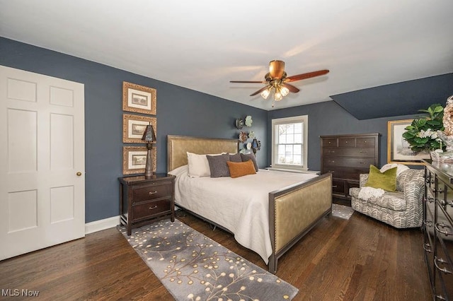 bedroom featuring dark wood-type flooring, ceiling fan, and baseboards