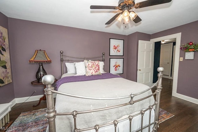 bedroom featuring a ceiling fan, dark wood-style flooring, and baseboards