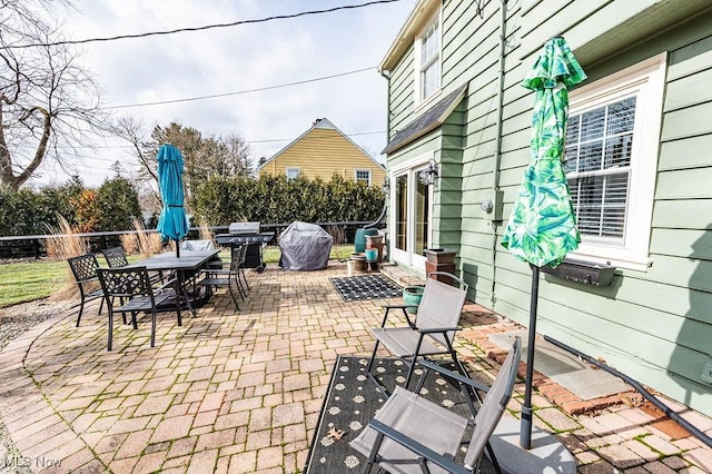 view of patio / terrace with fence, outdoor dining area, and area for grilling