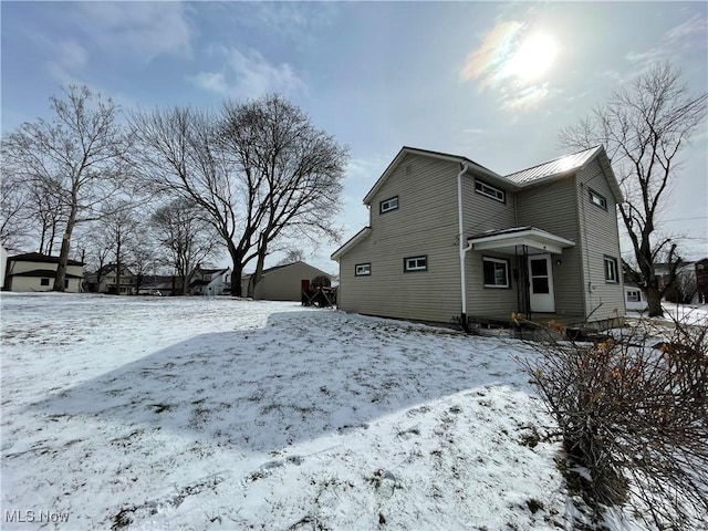 snow covered property featuring a garage