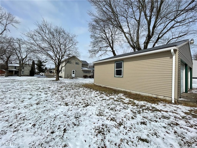 snow covered property featuring a garage