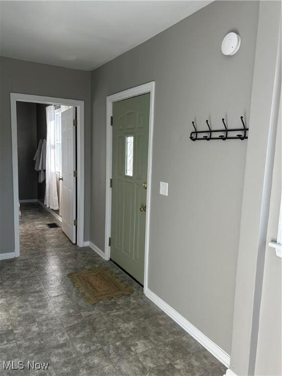 entryway with plenty of natural light, visible vents, and baseboards