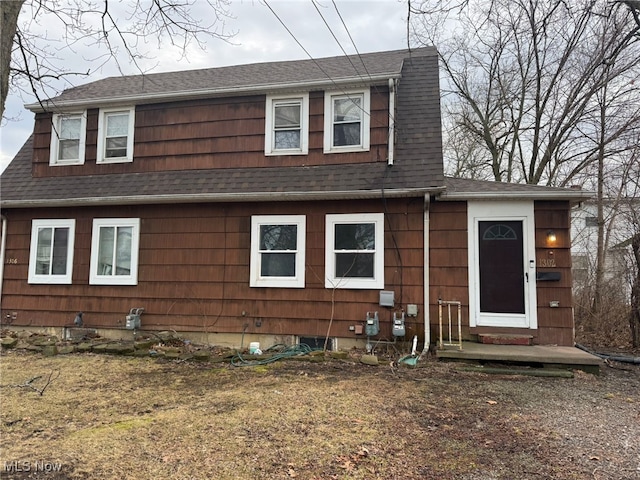 dutch colonial with a shingled roof