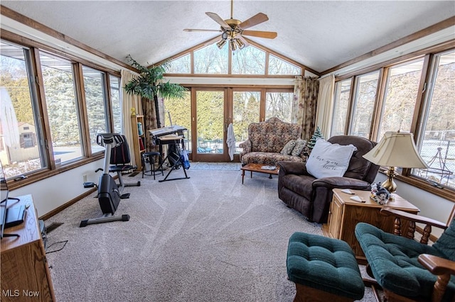 interior space featuring light carpet, baseboards, lofted ceiling, ceiling fan, and a textured ceiling