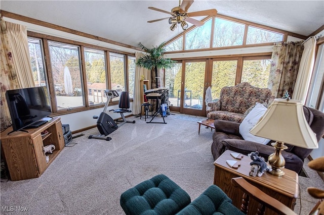 carpeted living room featuring a ceiling fan, lofted ceiling, and french doors