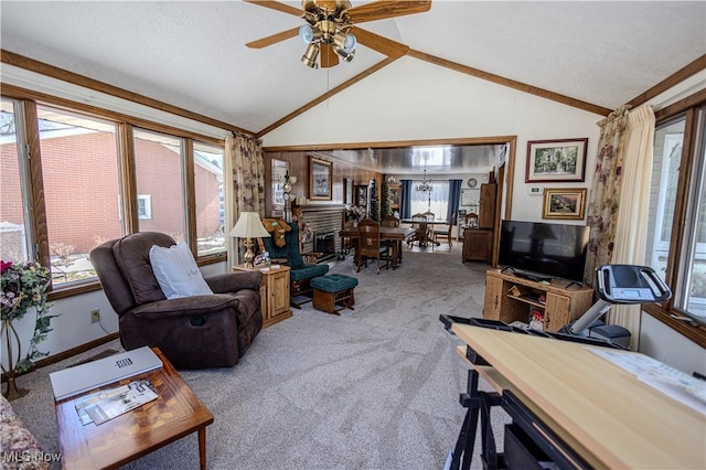 living room with vaulted ceiling, a brick fireplace, plenty of natural light, and light colored carpet