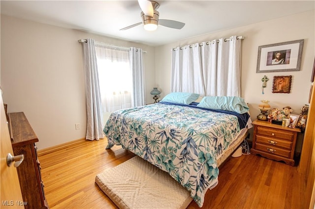 bedroom with ceiling fan and wood finished floors