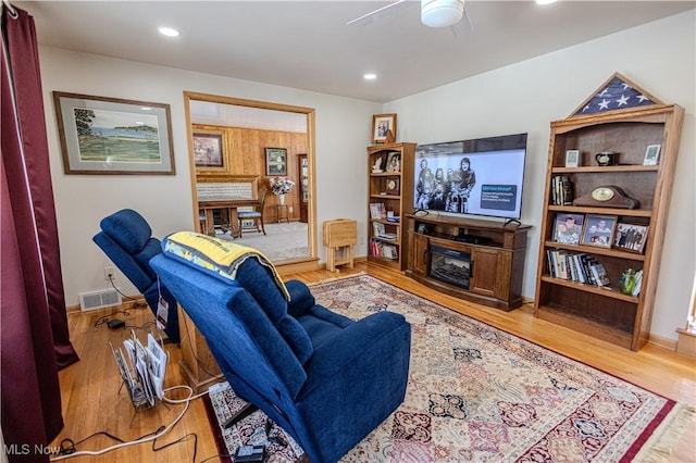 living room with a fireplace, recessed lighting, visible vents, ceiling fan, and wood finished floors