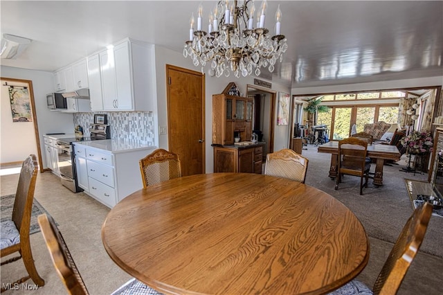 dining space with light carpet and french doors