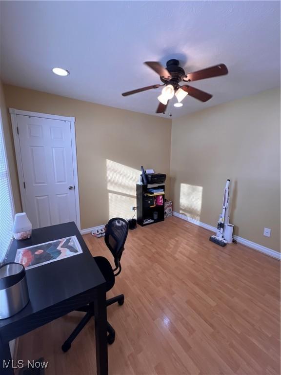 office space with recessed lighting, wood finished floors, a ceiling fan, and baseboards