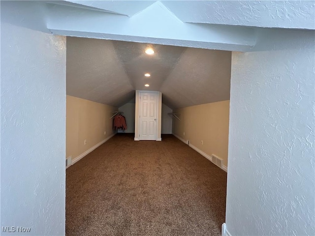 bonus room with vaulted ceiling, carpet flooring, visible vents, and baseboards