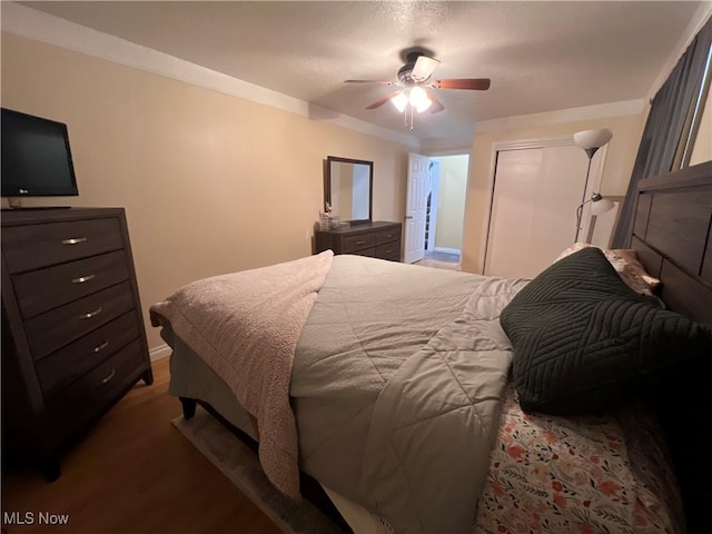 bedroom with ceiling fan, a closet, and wood finished floors