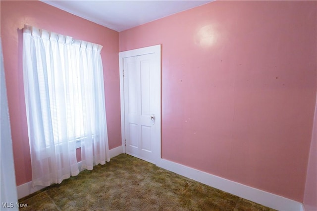 unfurnished bedroom featuring carpet and baseboards