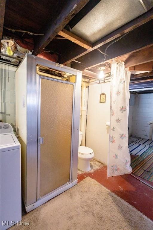 interior space featuring washer / clothes dryer and toilet