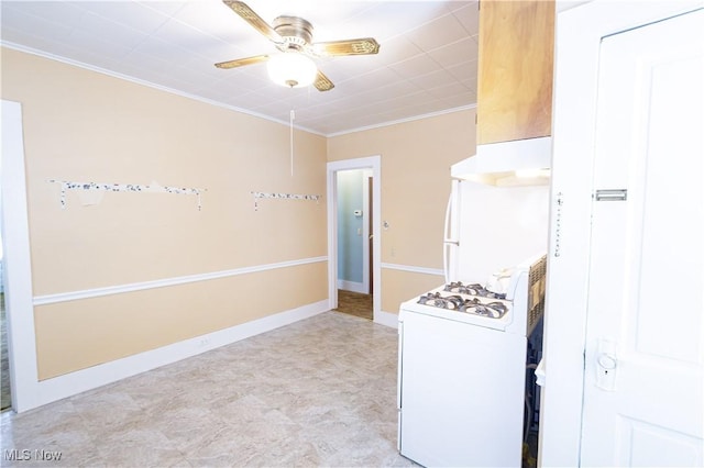 kitchen featuring ornamental molding, a ceiling fan, white appliances, under cabinet range hood, and baseboards