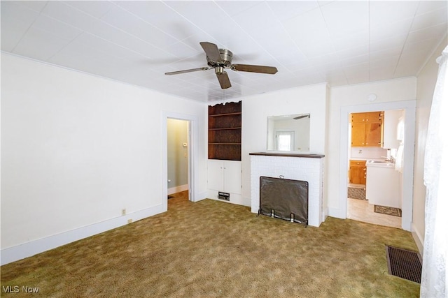 unfurnished living room with a ceiling fan, visible vents, a fireplace, and carpet flooring