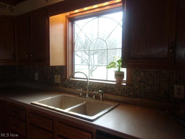 kitchen featuring tasteful backsplash and a sink