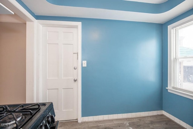 interior space with baseboards and wood finished floors