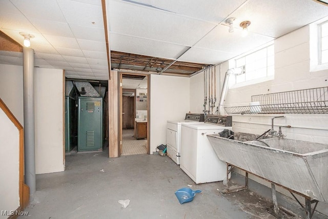 below grade area featuring washing machine and dryer and a sink