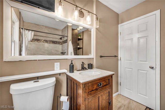 full bath featuring toilet, curtained shower, and vanity