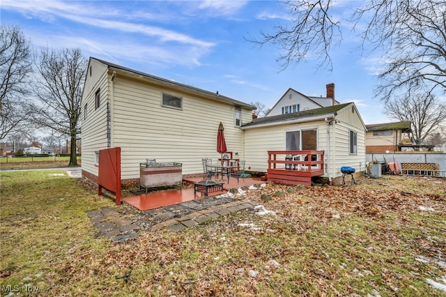 rear view of house featuring a deck and a patio area