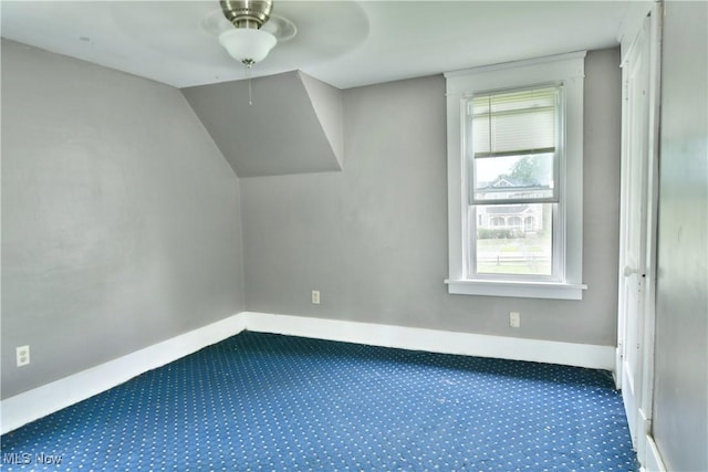 bonus room with carpet floors, baseboards, and vaulted ceiling