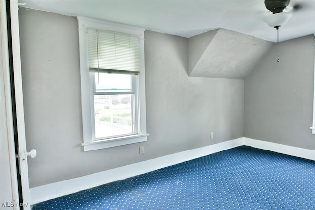 additional living space with lofted ceiling, carpet flooring, and baseboards