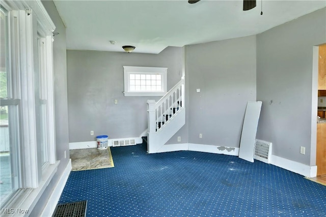 interior space featuring stairs, visible vents, and baseboards