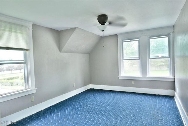 additional living space featuring carpet floors, ceiling fan, baseboards, and vaulted ceiling