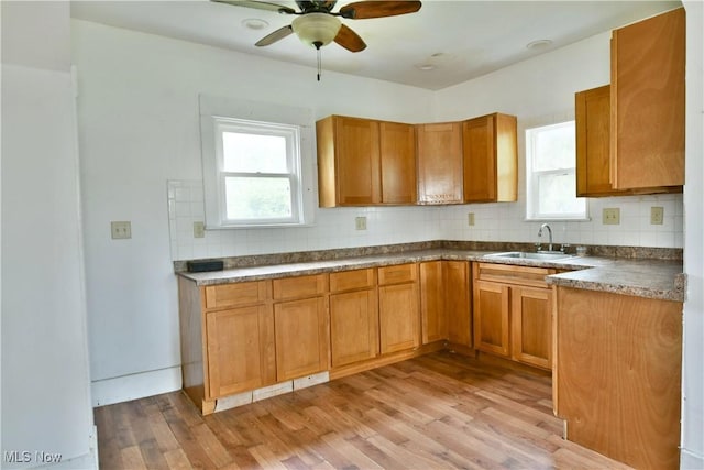 kitchen with a wealth of natural light, brown cabinets, and a sink