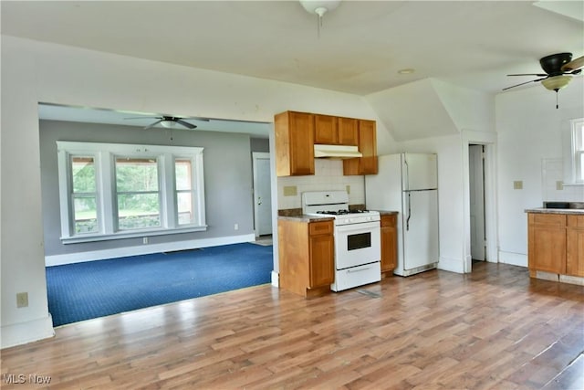 kitchen with ceiling fan, under cabinet range hood, white appliances, open floor plan, and brown cabinets