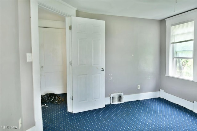 unfurnished bedroom with visible vents, baseboards, and carpet flooring