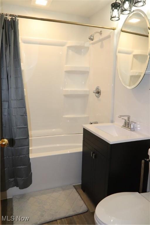 bathroom featuring vanity, toilet, and shower / bath combo with shower curtain