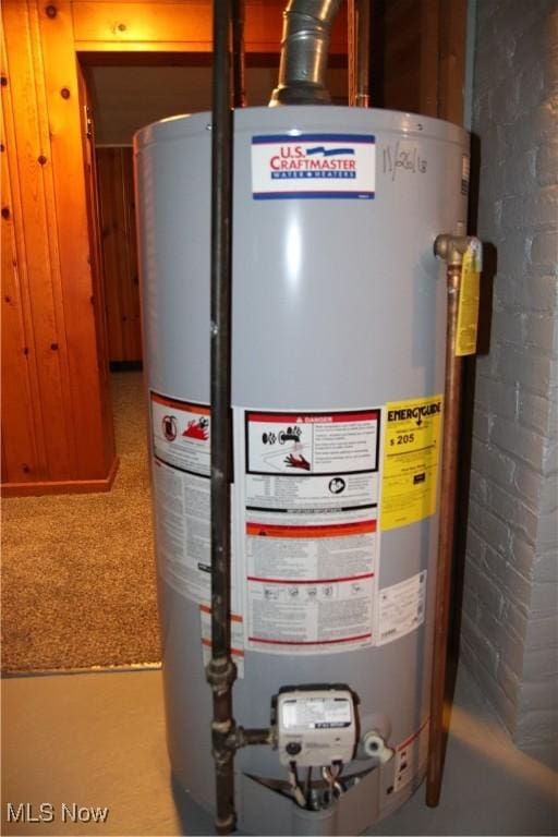 utility room featuring water heater