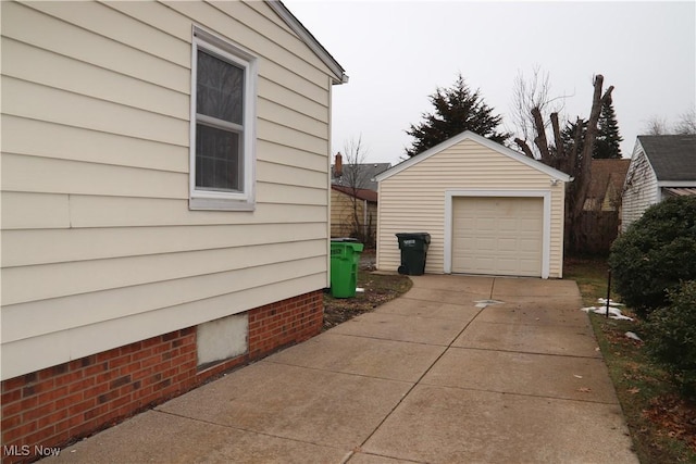 view of property exterior with a garage, driveway, and an outdoor structure