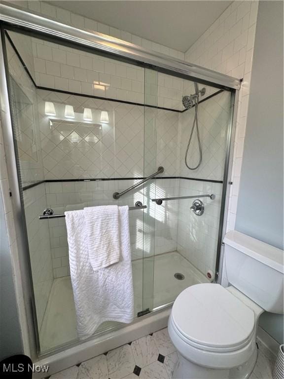 full bathroom with a stall shower and toilet