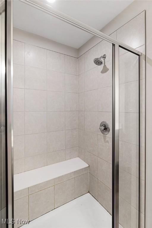 full bath with a shower stall