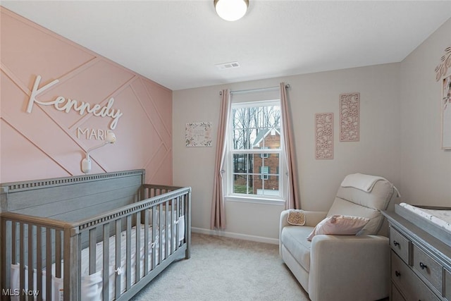 bedroom with light carpet, a crib, visible vents, and baseboards