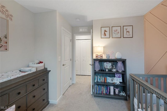 hallway featuring baseboards and light colored carpet