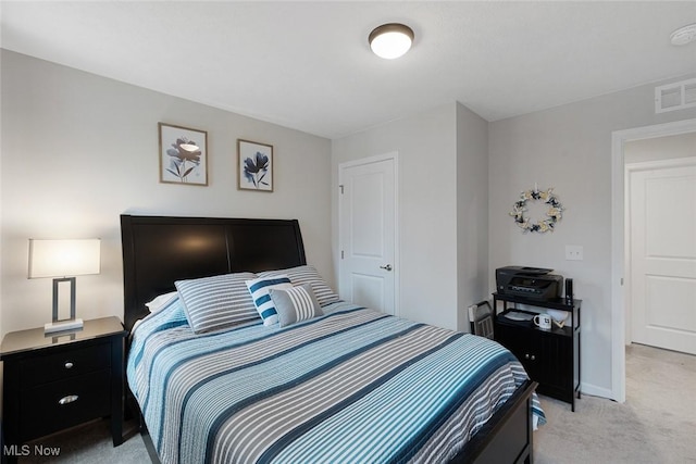 bedroom with light carpet, visible vents, and baseboards