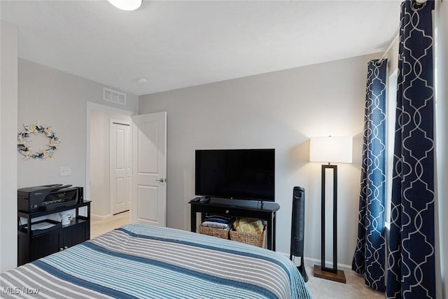 bedroom featuring carpet floors, visible vents, and baseboards